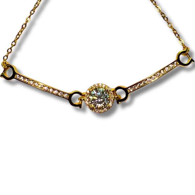 Gold necklace with a central moissanite on a white background