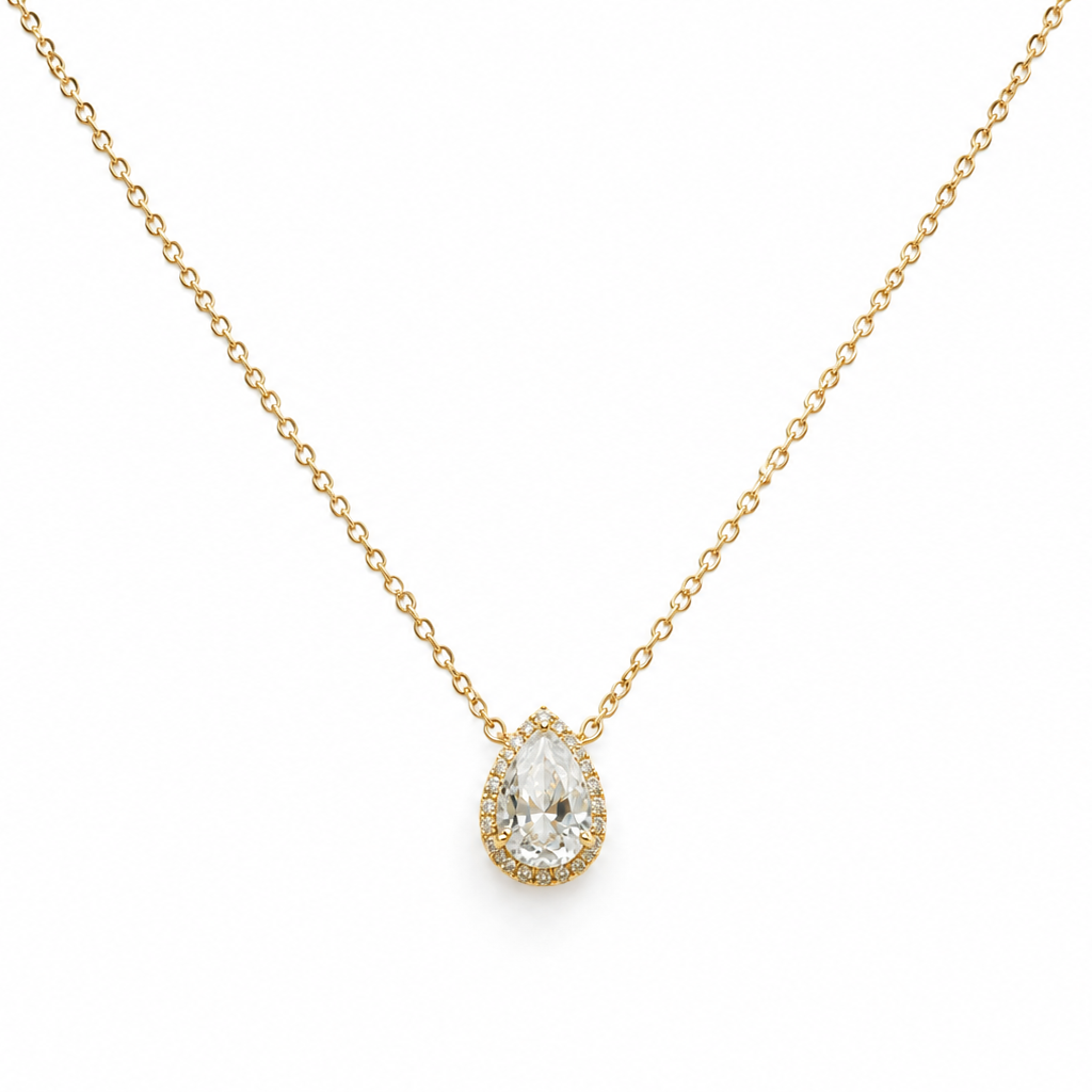 Gold necklace with a teardrop-shaped diamond pendant on a white background