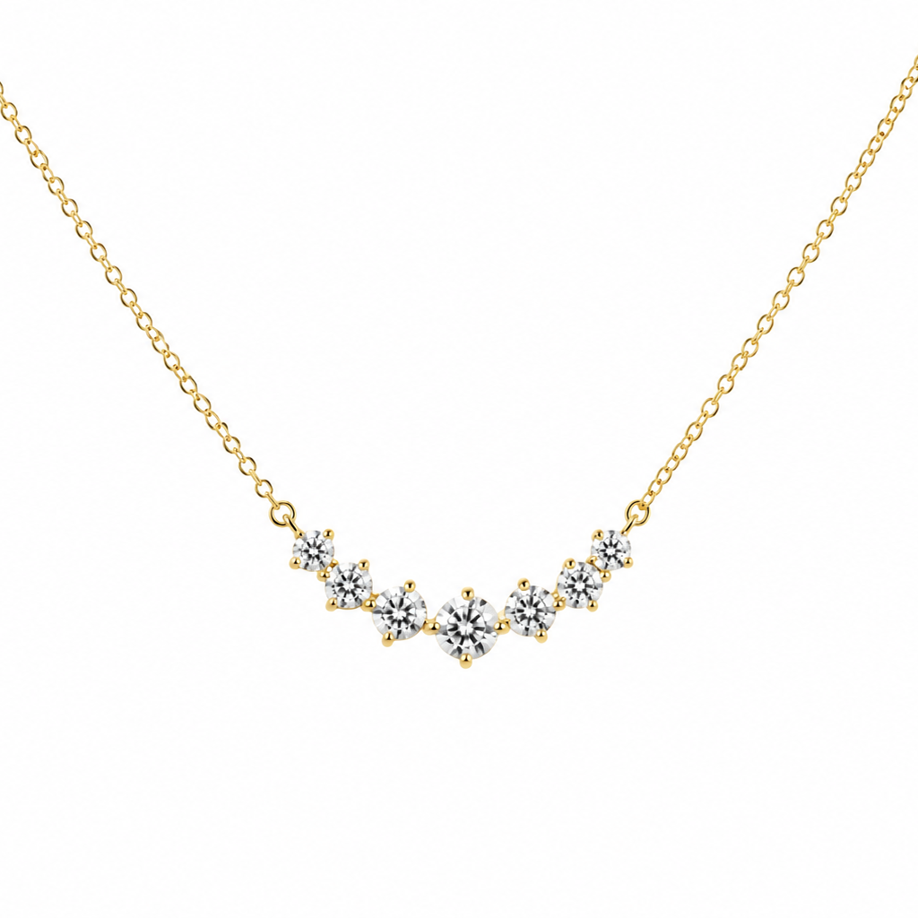 Gold necklace with a V-shaped diamond pendant on a white background