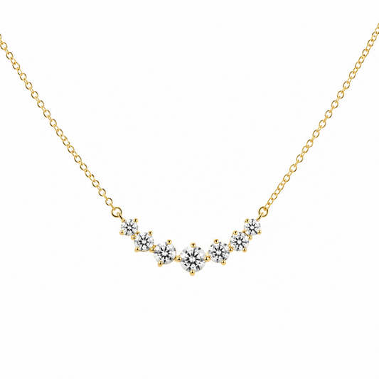 Gold necklace with a V-shaped diamond pendant on a white background