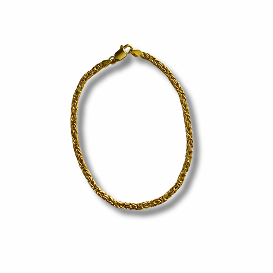 Gold chain bracelet on a white background